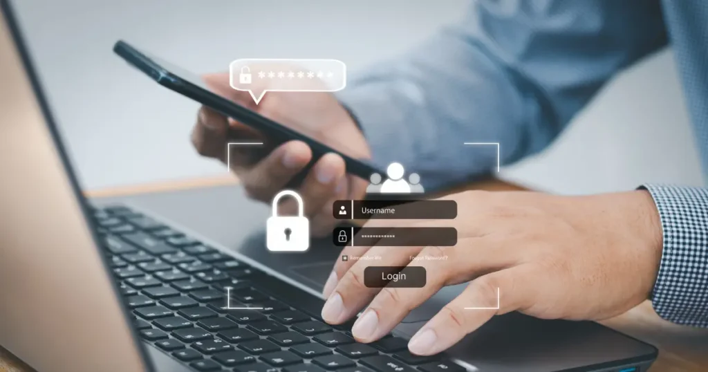 Business user logging in on a laptop while confirming a code on a mobile phone with two-factor authentication icons
